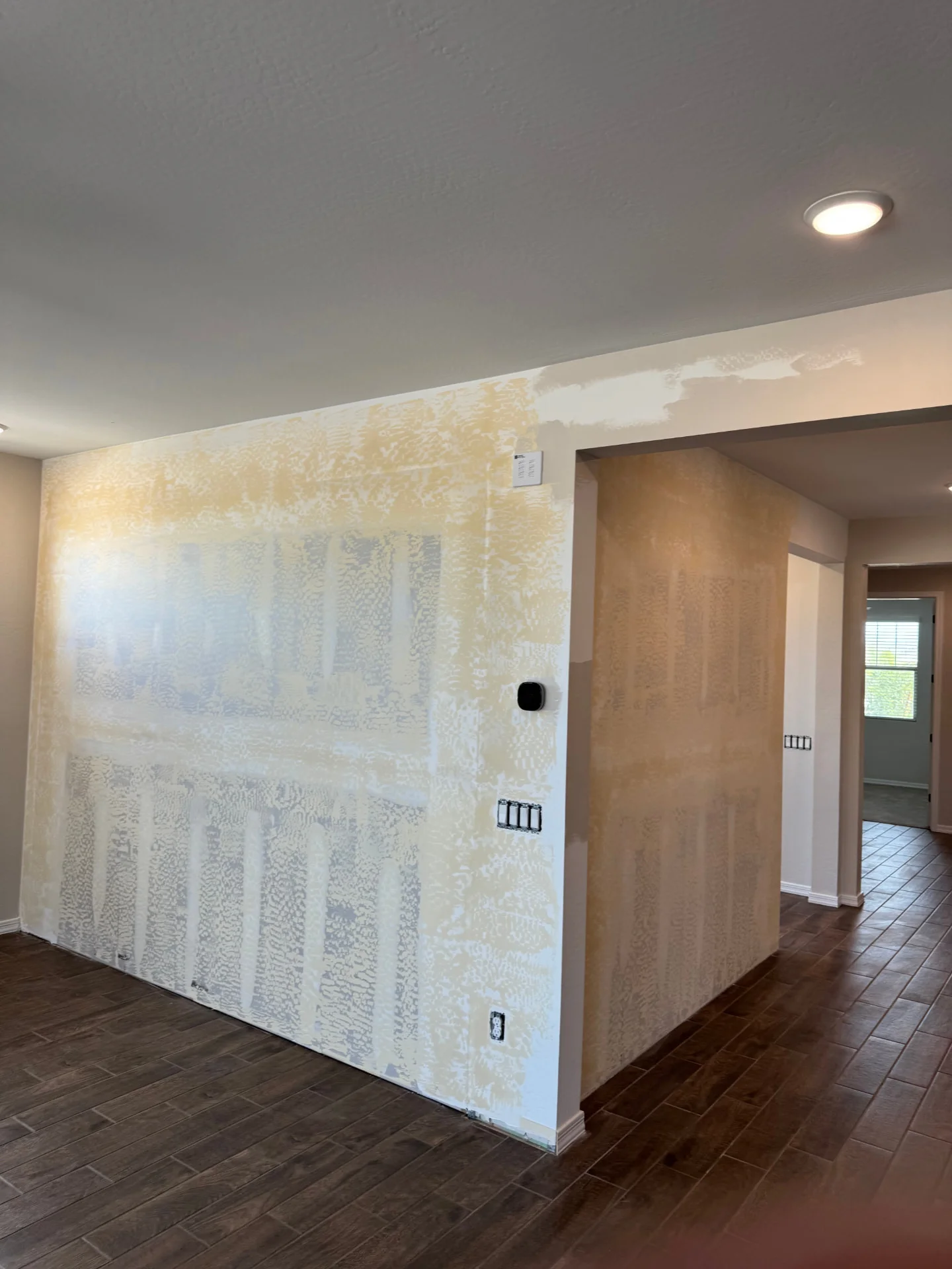 Interior walls prepped for texture with mud and tape visible across the surface